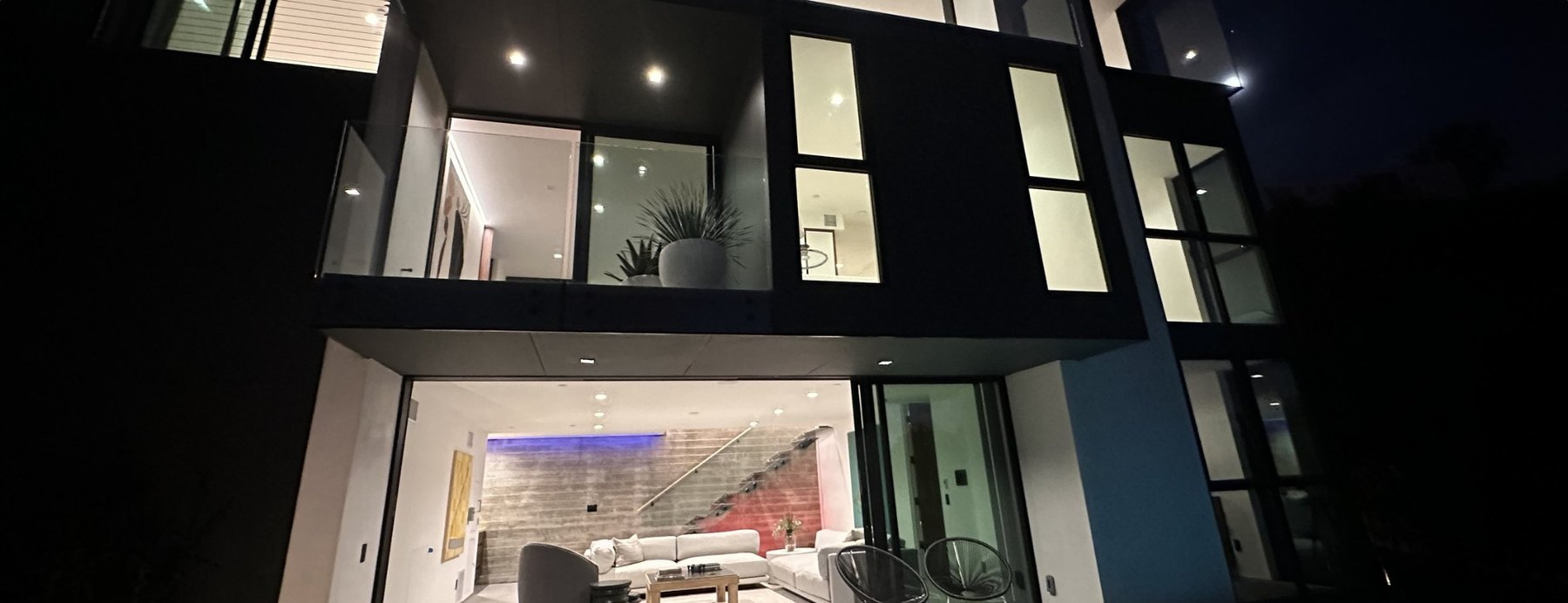 Hargrave Dr. at night: a modern three-storey home lit throughout