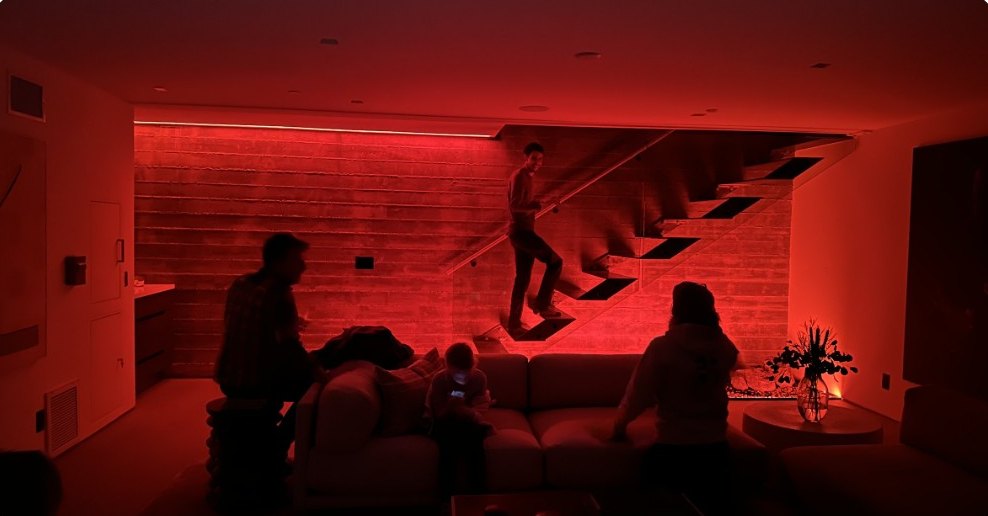 Guests on a staircase washed in deep red light