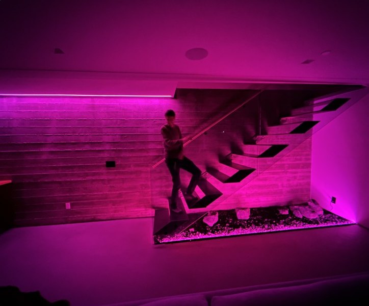 A staircase washed in saturated magenta light