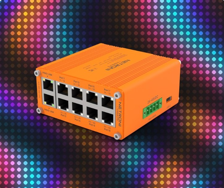 An orange XP-Pix module in front of a wall of colorful addressable pixels